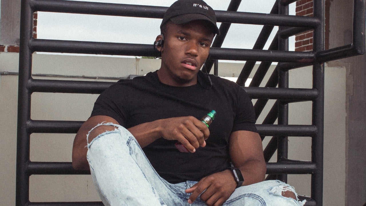 african american vaping on the stairs